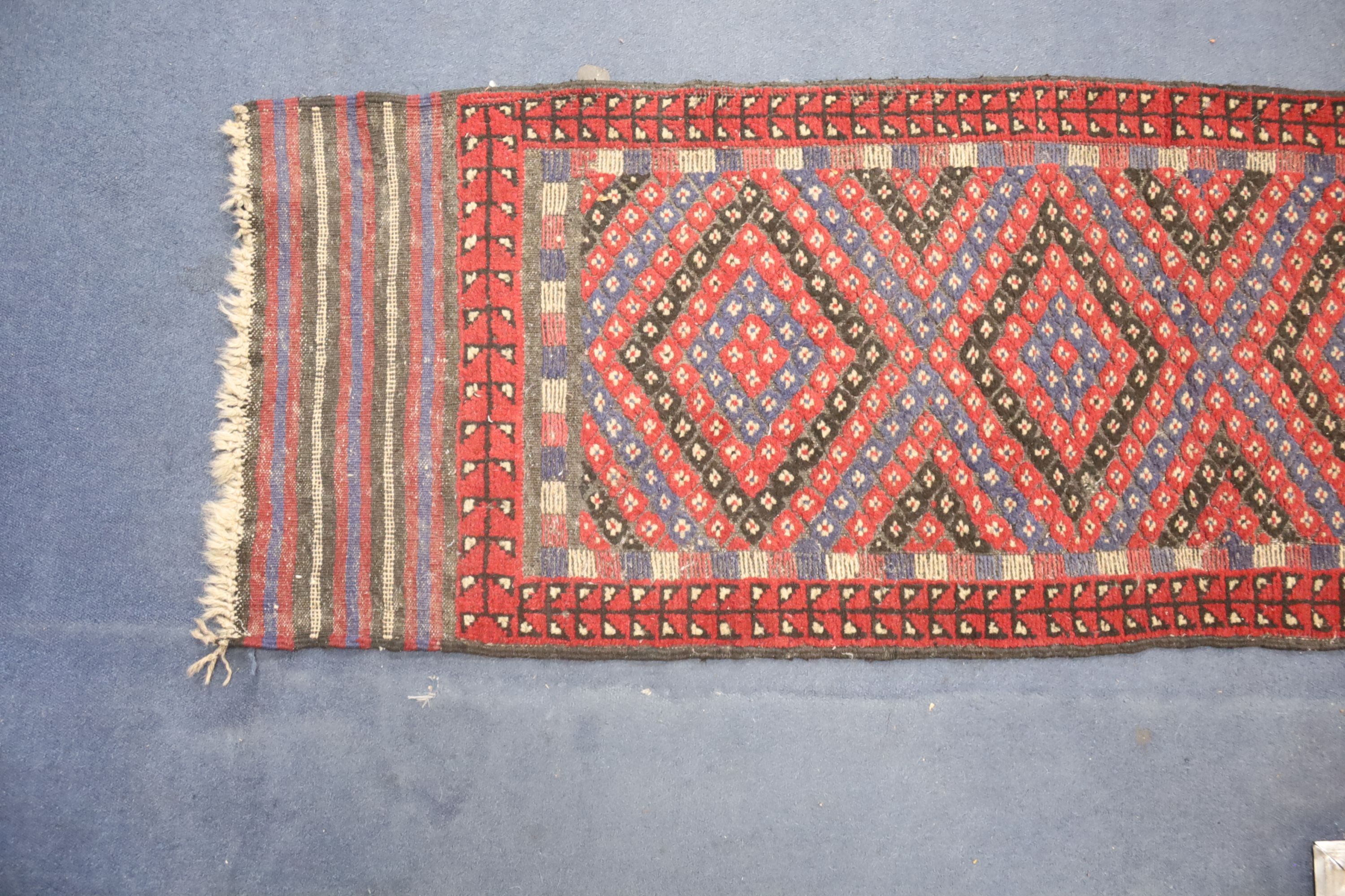 A Kelim polychrome geometric runner, 240 x 59cm